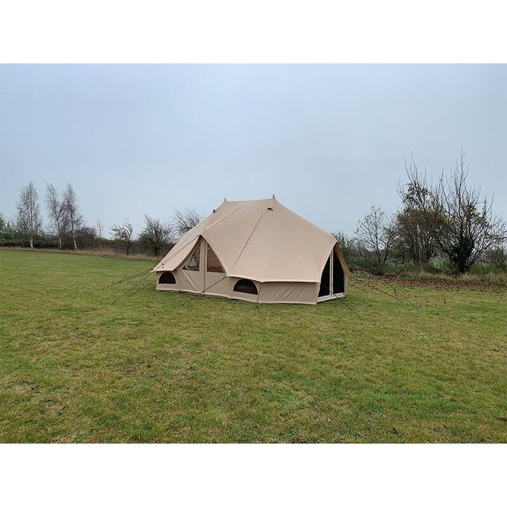 Side and rear view of Quest Leisure Signature Emperor bell tent on a grassy field with trees.