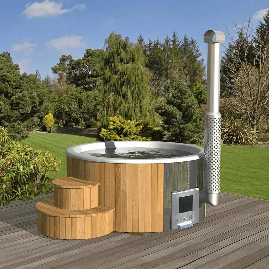 InMedias Delux 200 Hot Tub filled with water, surrounded by a green garden and trees, on a wooden deck under a sunny sky.