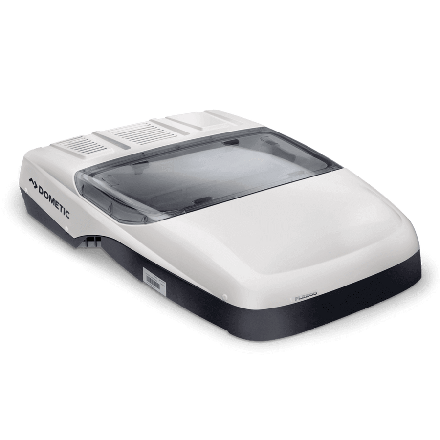 Angled view of the Dometic FreshLight 2200 rooftop air conditioner in a white and dark grey finish. The unit features a built-in integrated skylight window with a clear dome, visible ventilation grilles at the rear, and sleek aerodynamic contours, on a transparent background.