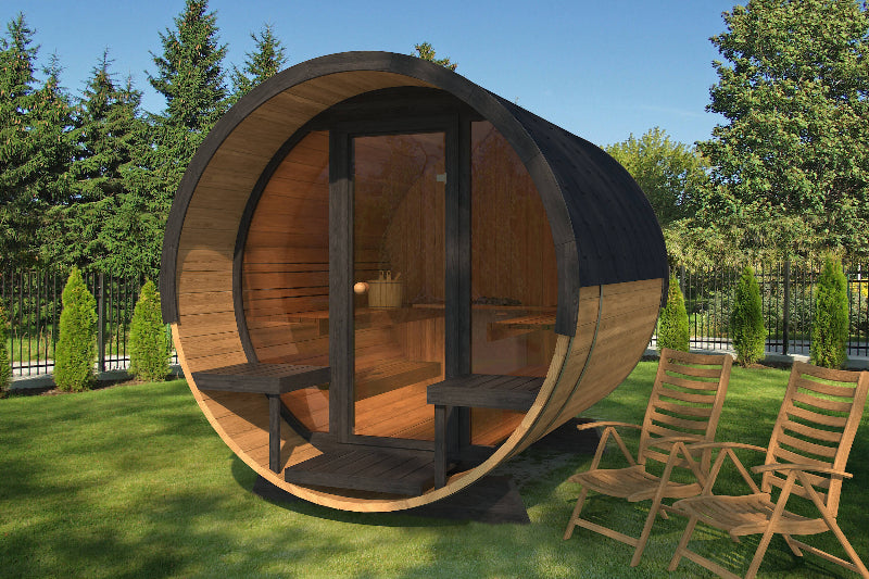 Daytime of InMedias Barrel Sauna 280 Deluxe with black framing and transparent glass front, on a lawn background.