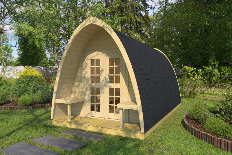 Exterior of InMedias Camping Pod 480 with double doors and outdoor seating on a grassy lawn surrounded by trees.
