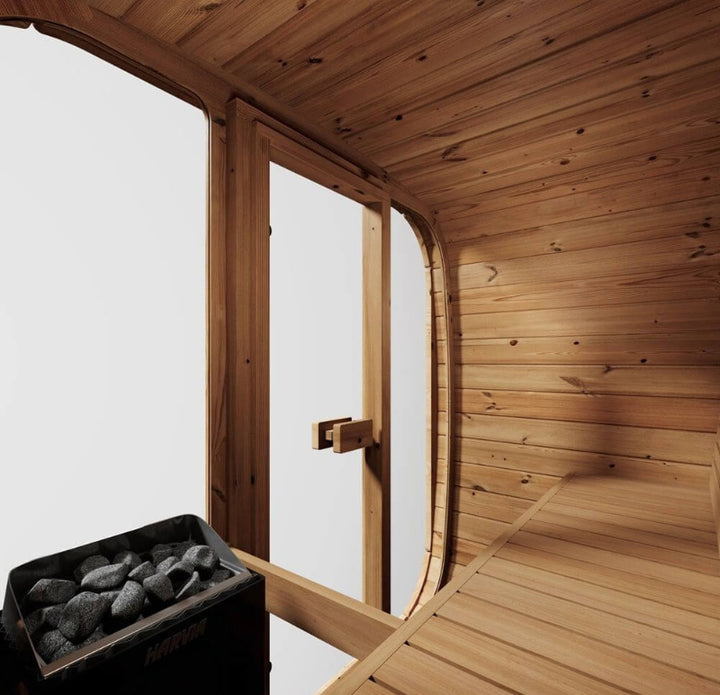InMedias Sauna Icon 125 interior close-up – inside view looking toward the glass door and heater, showing curved wood walls and bench .