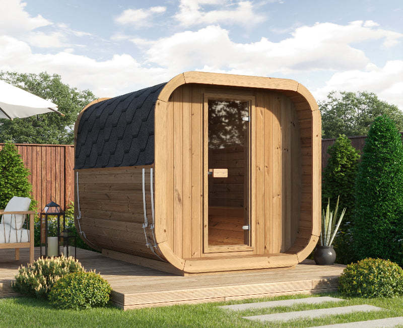 Outdoor placement of the InMedias Sauna Icon 250S on a wooden deck with surrounding greenery and blue sky.