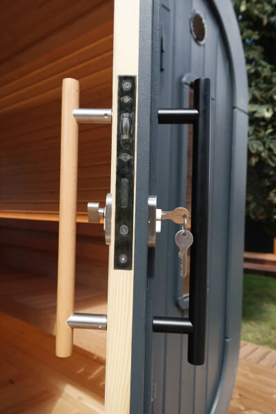 Close-up of door lock and dual-tone handles on Viking Industrier Luna Outdoor Sauna 2.3 x 2.4m, with the door slightly open.