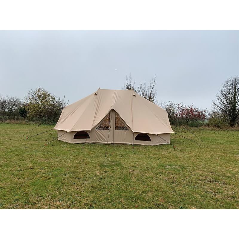 Quest Leisure Signature Emperor bell tent on a grassy field under a cloudy sky.