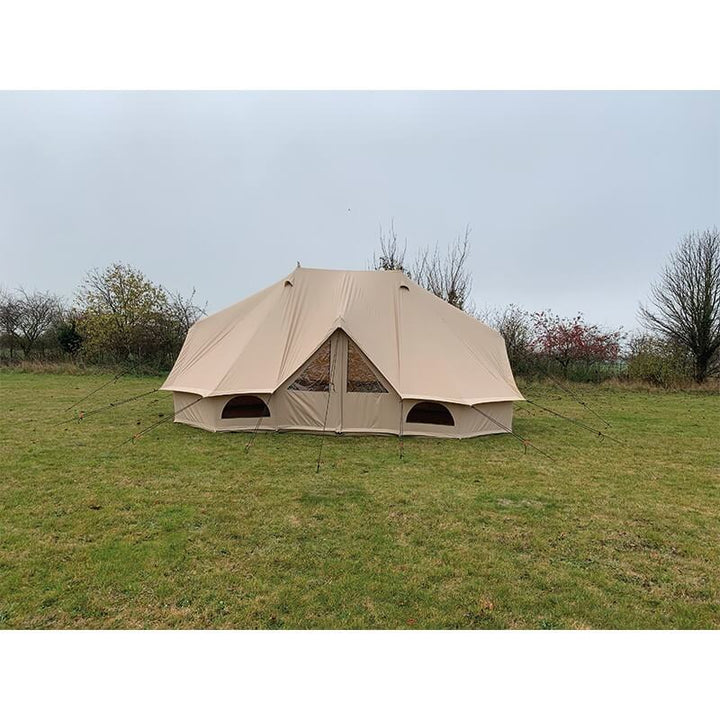 Quest Leisure Signature Emperor bell tent on a grassy field under a cloudy sky.