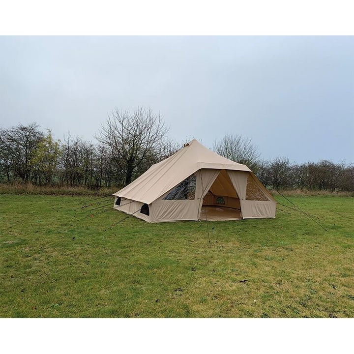 Rear-side view of the Quest Leisure Signature Touareg bell tent in a grassy field under a cloudy sky.
