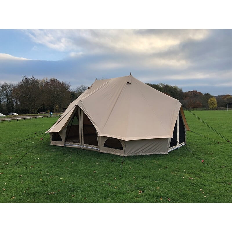 Quest Leisure Signature Emperor bell tent with open doors on green grass with trees in the background.