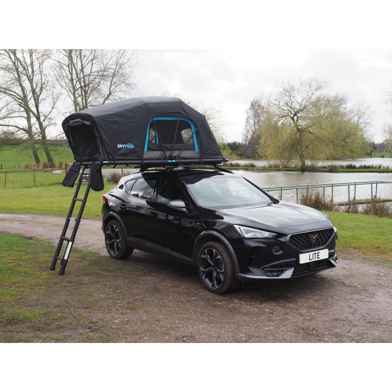 Skypod Lite rooftop tent fully opened on a black car with ladder, ideal for lightweight outdoor camping adventures.
