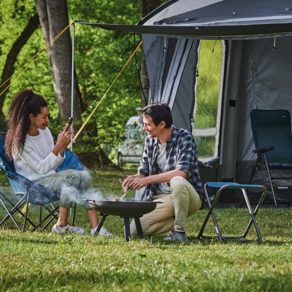 Trigano Phuket Inflatable Drive Away Awning shown being used by a couple close up