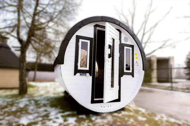 White-painted Viking Industrier Barrel Sauna 2.2 x 3m with black-framed windows and open door.