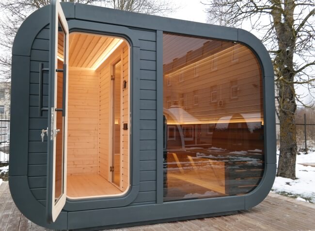 Open door view of Viking Industrier Luna Outdoor Sauna 3.3 x 2.4m showing both rooms, on a snowy background.