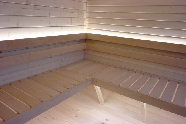 Close-up of L-shaped wooden sauna bench in Viking Industrier Luna Outdoor Sauna 3.3 x 2.4m.