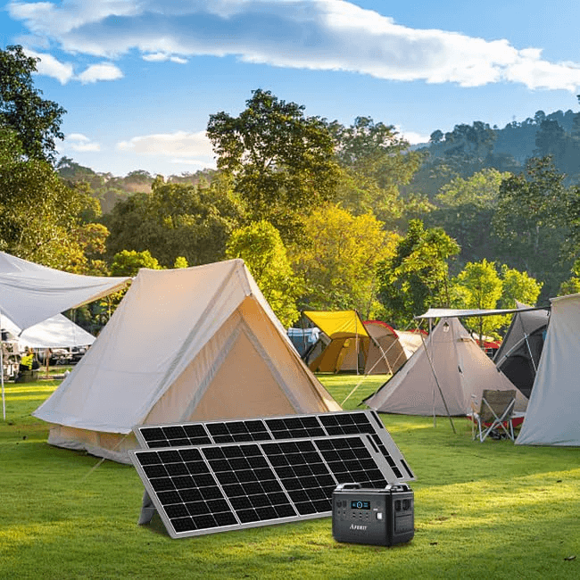 Aferiy 2001A portable power station positioned outdoors at a campsite, paired with a foldable solar panel in front of tents and trees, on a white background.