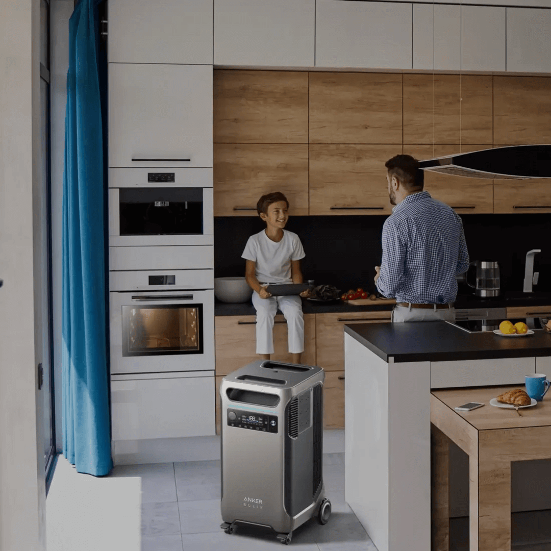 Anker portable power station in modern kitchen setting, powering appliances with family in background.