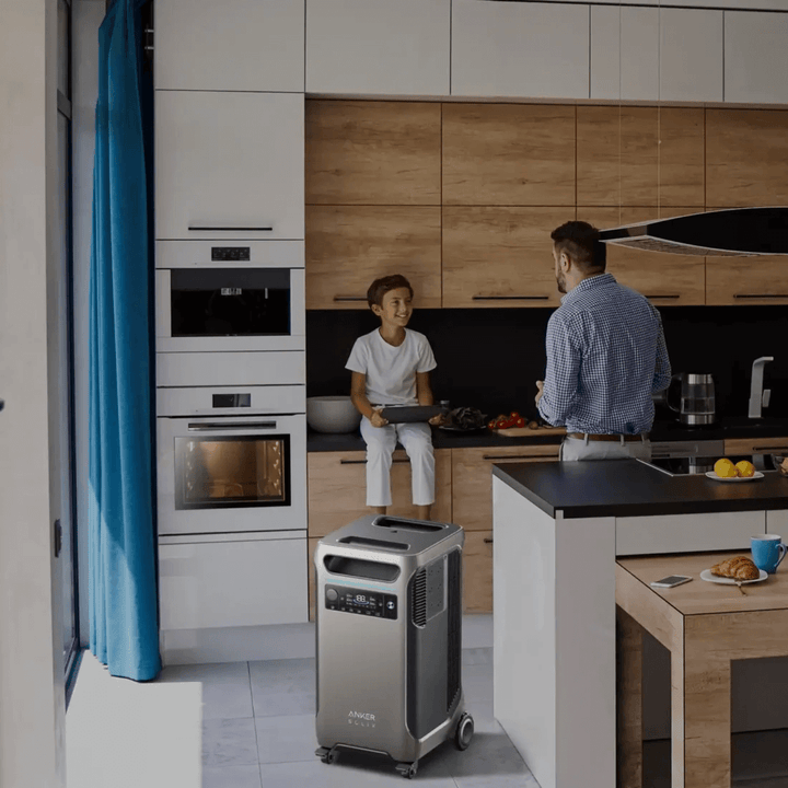 Anker portable power station in modern kitchen setting, powering appliances with family in background.