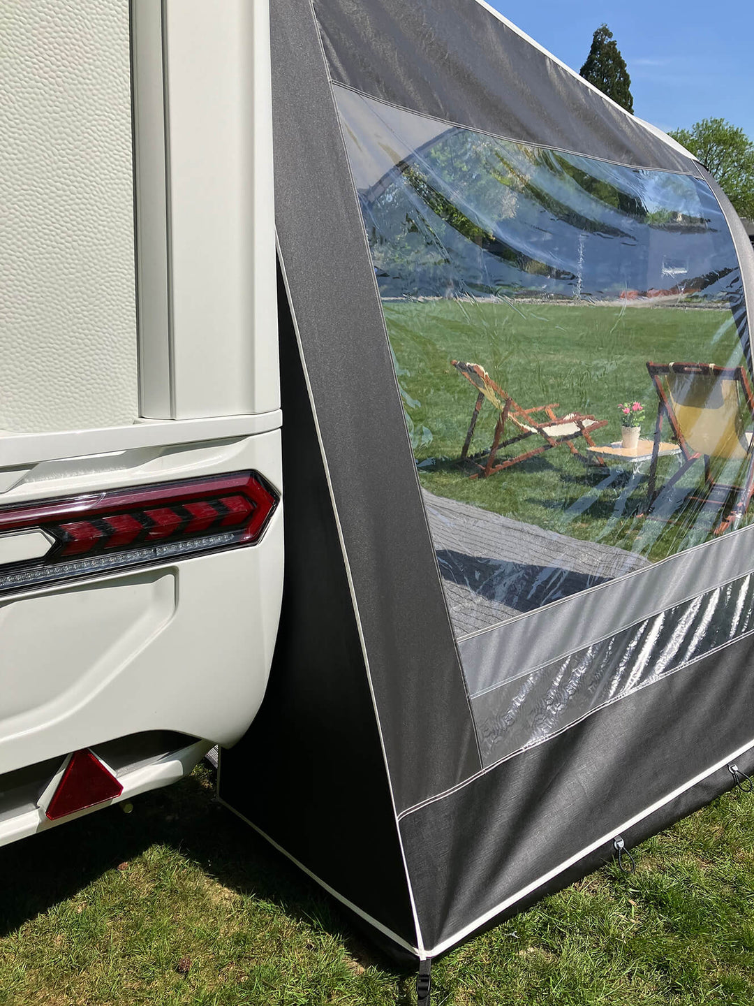 Rear corner view of Walker Combi-Luxe awning attached to caravan with transparent side window.