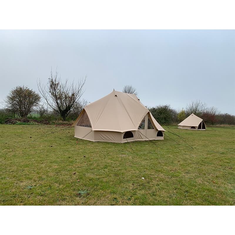 Side view of Quest Leisure Signature Emperor bell tent on a grassy field with a smaller tent in the background.