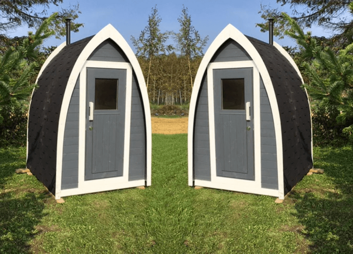 InMedias Toilet Barrel twin units with gray-and-white painted wood finish, placed symmetrically on green lawn under blue sky – outdoor grassy background.