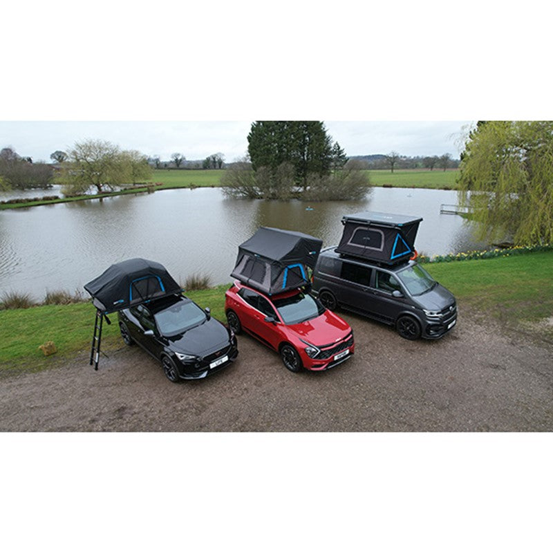 Cars and campervan fitted with Skypod rooftop tents parked beside a scenic lake.