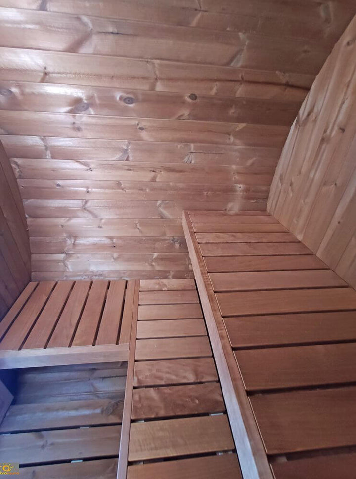 Angled interior ceiling view of InMedias Terrace Sauna showing horizontal wood planks and overlapping benching detail.