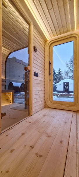 Wooden floor and front door view from inside the changing room of Viking Industrier Luna Outdoor Sauna 3.3 x 2.4m.