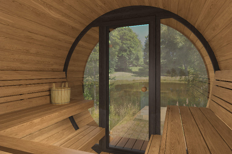 Interior angled view of InMedias Barrel Sauna 280 Deluxe facing the glass door with nature visible outside.
