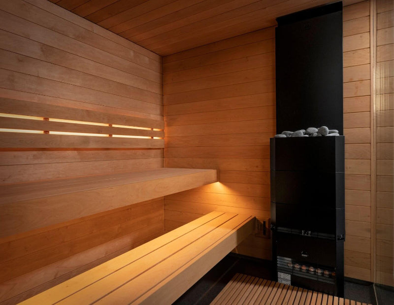 Interior view of the Saunum Classic sauna featuring tiered wooden benches and a modern black electric heater.
