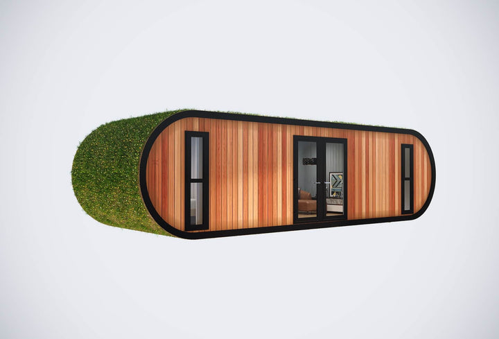 Angled view of a modern glamping pod with rounded grass-covered ends, vertical wood panels, and black-framed windows and doors, on a white background.