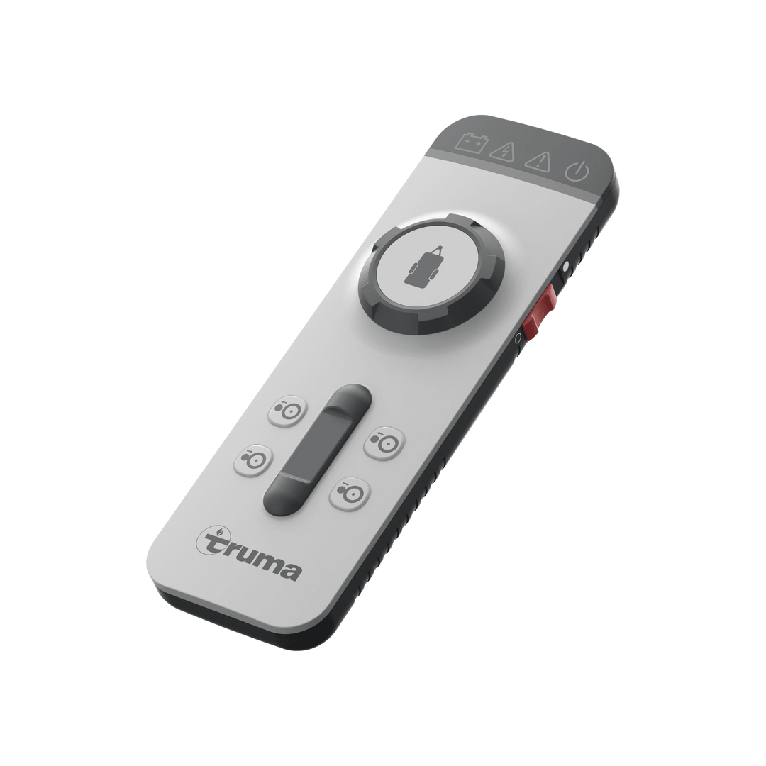 Truma Mover XT 4 remote control unit with directional buttons and a central joystick for maneuvering a caravan, on a transparent background.