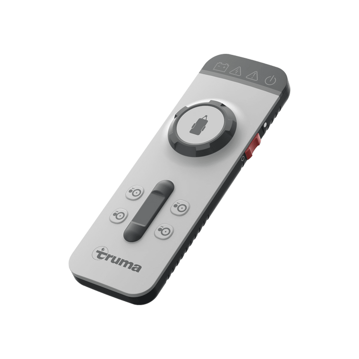 Truma Mover XT 4 remote control unit with directional buttons and a central joystick for maneuvering a caravan, on a transparent background.
