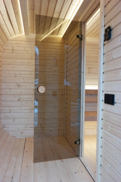 Glass door inside the Viking Industrier Luna Outdoor Sauna 3.3 x 2.4m, separating sauna from changing room.