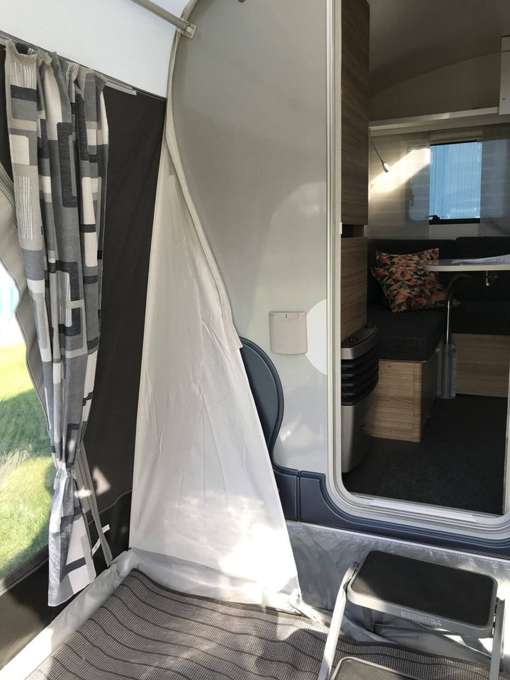 Open entrance of the Adria Action 391 caravan seen from inside the Walker awning, with step stool in front.