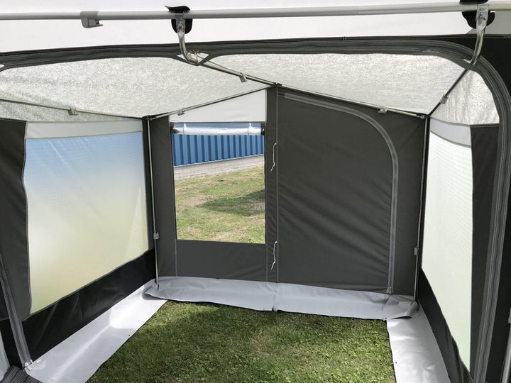 Interior view of Walker Touring-Plus awning, showing durable fabric walls, window openings, and curved roof poles.