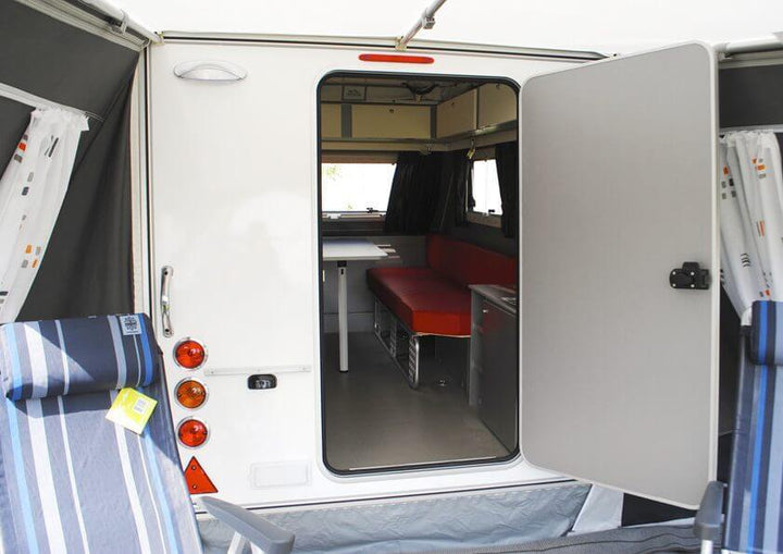 Rear access into caravan through Walker Kip Shelter Awning showing open door and visible interior seating.