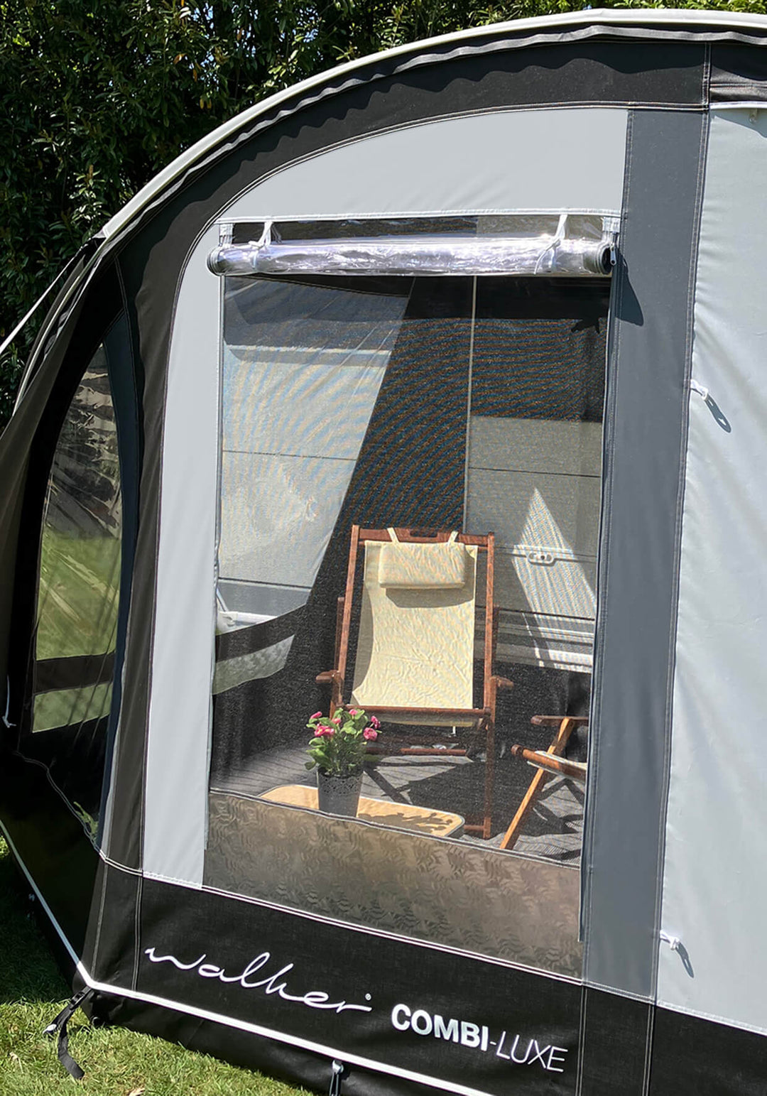 Close-up of Walker Combi-Luxe side panel with mesh window and view of lounge chair and table inside.