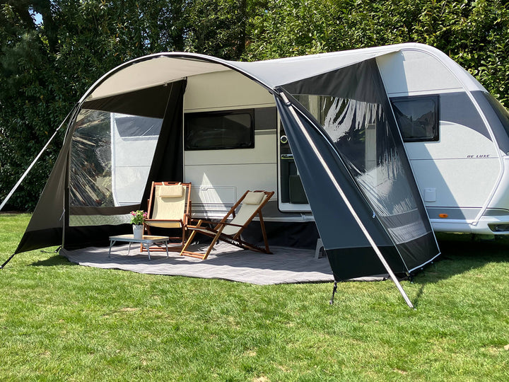Side view of Walker Combi-Luxe awning open on both ends, showing chairs and relaxed outdoor setup.