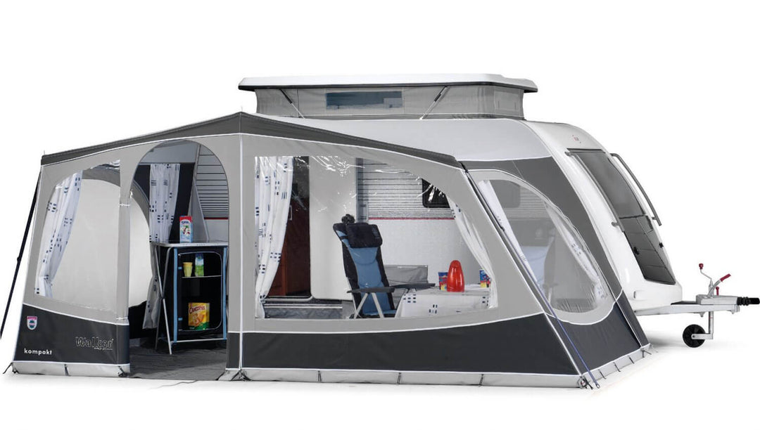 Walker Kip Kompakt awning fully enclosed with curtains, side windows, and visible interior setup including chairs and table, with white background.