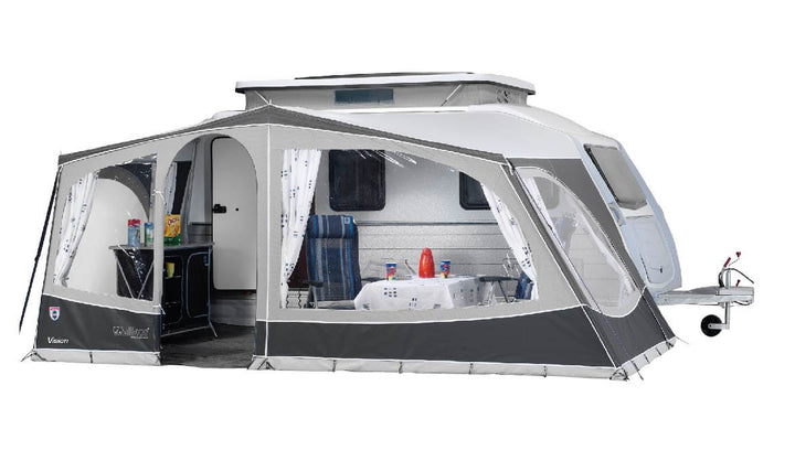 Open setup of the Walker Kip Vision awning providing shaded outdoor space, with two chairs and a table in front of the Kip Vision caravan, on white background.