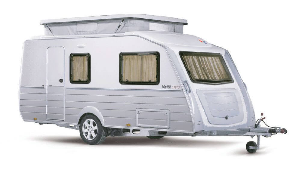 Side profile of the Kip Vision 41TQ caravan with raised pop-top roof, no awning attached, parked on plain white background, on white background.