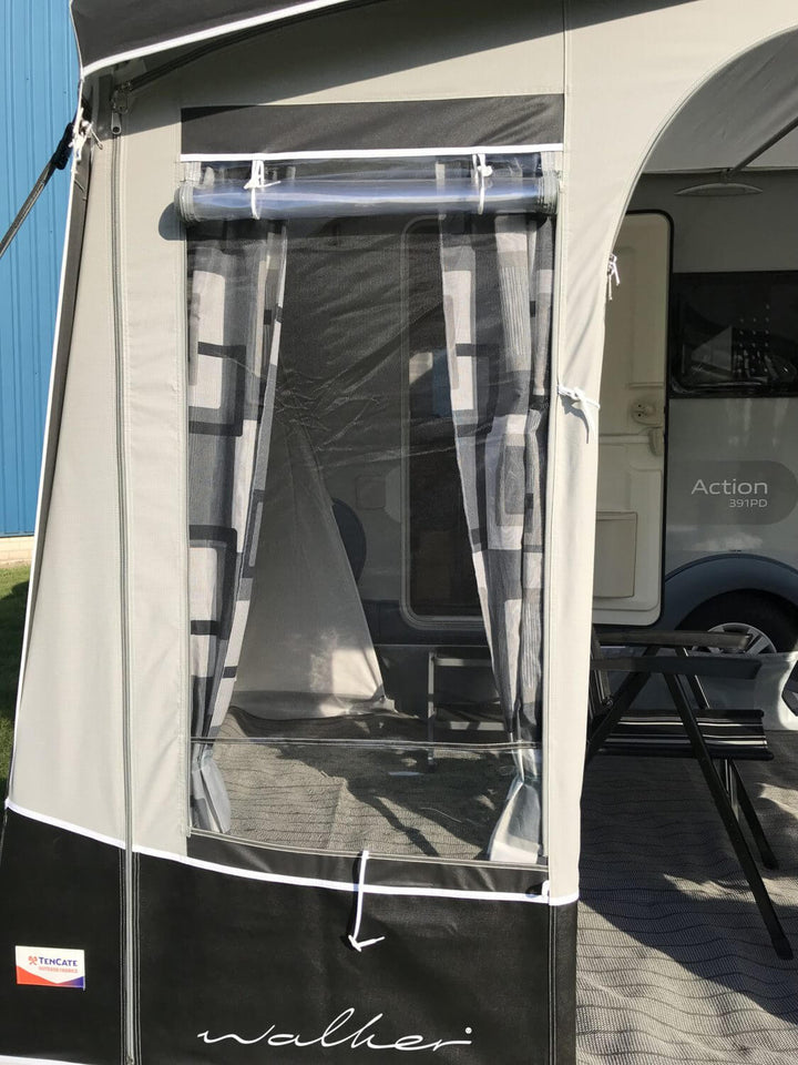 Close-up of the front window panel on the Walker awning, showing the mesh window, curtain, and branding.