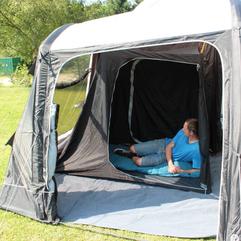 A man lying inside an inner tent inside a caravan awning