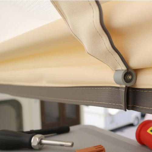 Close up of a caravan awning's fabric with a tool