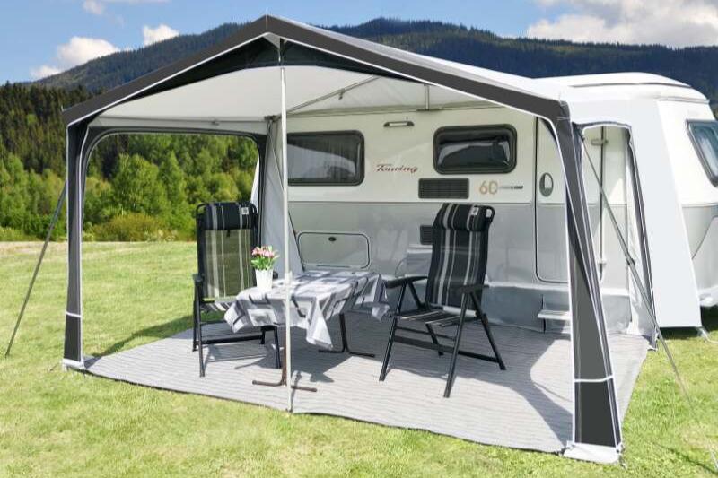 A Walked Awning with poles with the front panels removed, shown in a field in the sun