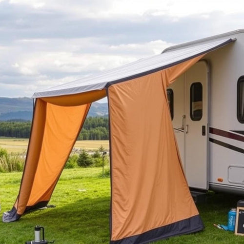 An orange caravan awning connected to a caravan in a field