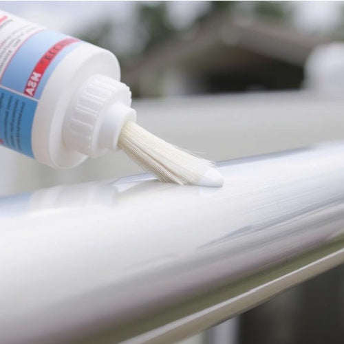 Close up of a bottle putting a lubricant on a caravan awning rail