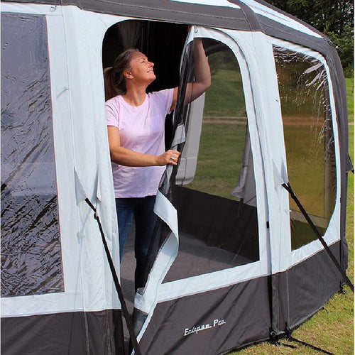 A woman in a pink shirt putting a caravan air awning
