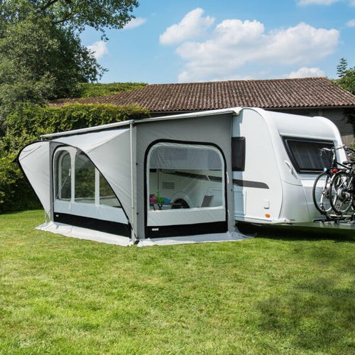 A Thule QuickFit Caravan Awning on grass next to a caravan