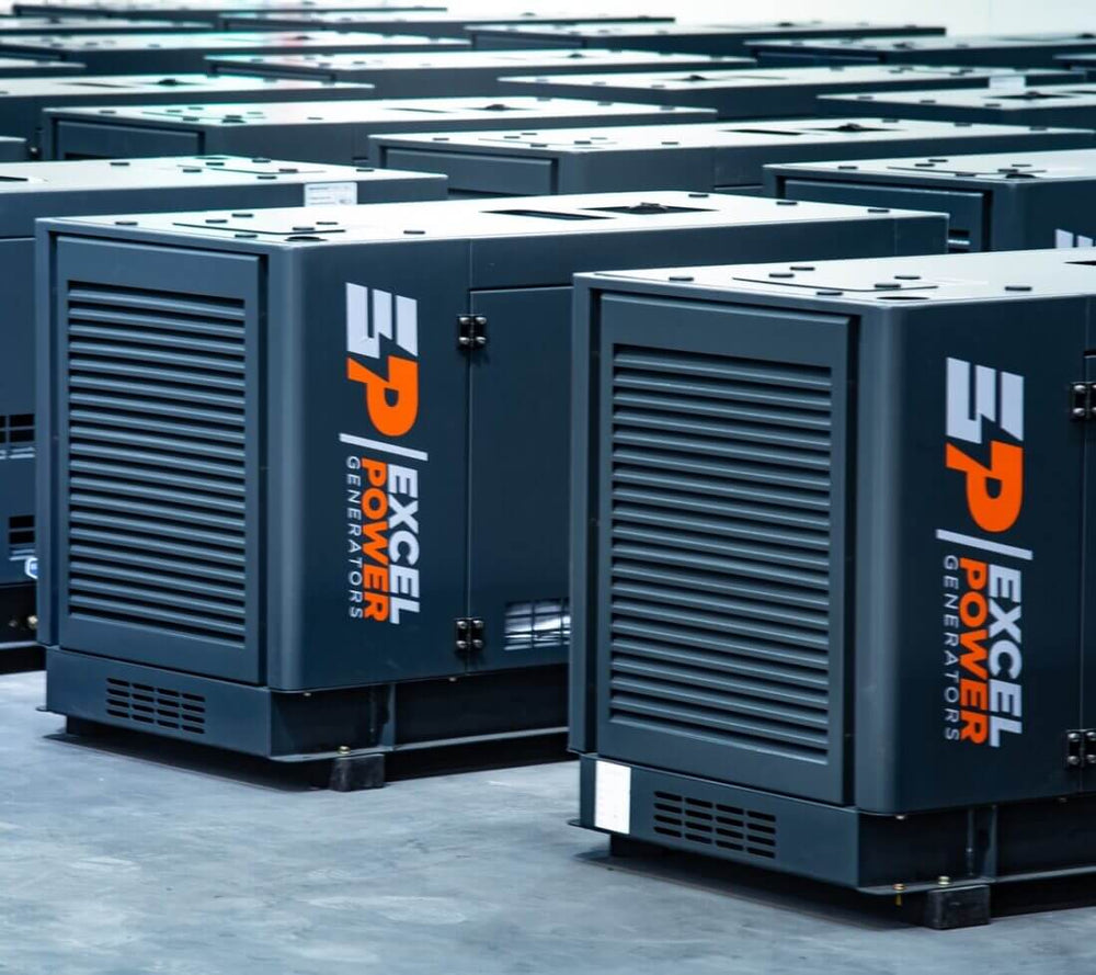 Row of Excel Power 10kVA diesel generators in a factory floor setting, showing multiple units with side ventilation and branding.