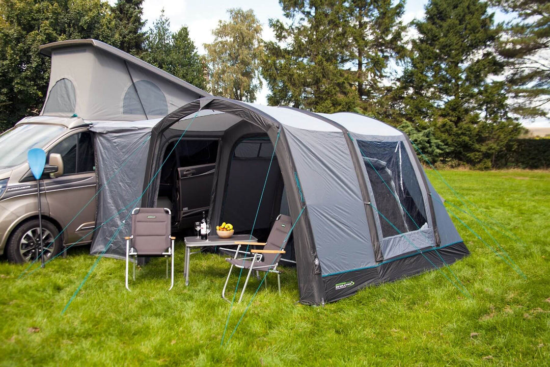 Rear angled view of the Outdoor Revolution Cayman Air T3 Lite driveaway awning connected to a campervan on a grassy campsite.